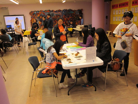 Staff and children busy at an activity station