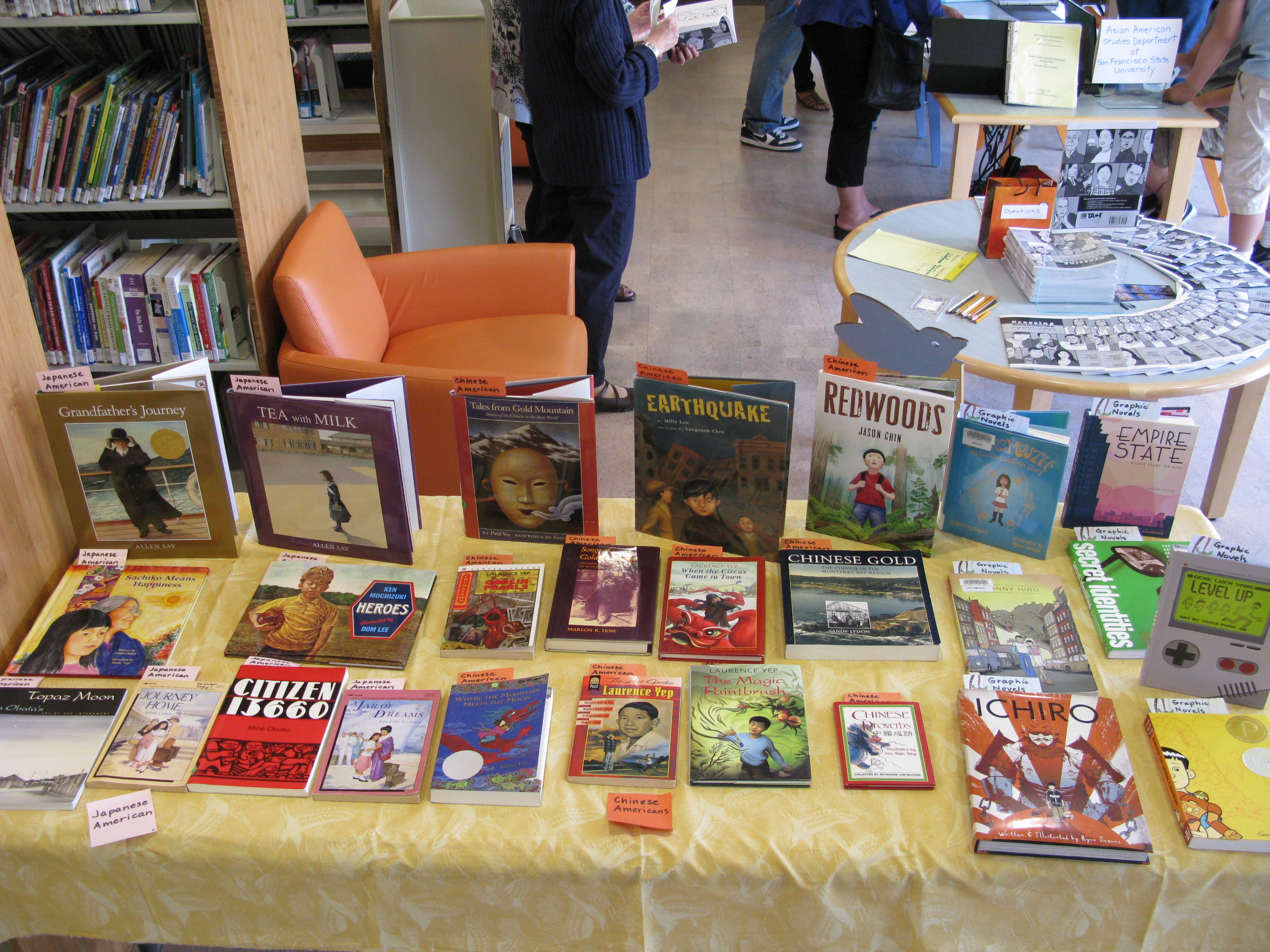 Books standing and laid out on a table for display