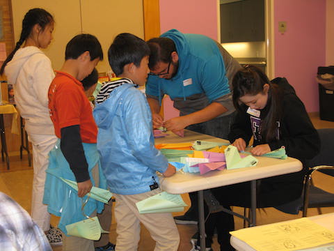 Children making paper airplanes
