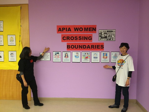 Two adults posing by APIA Women Crossing Boundaries Display