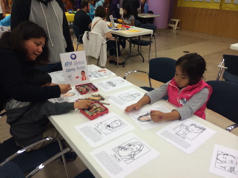 Child coloring at APIA Women coloring station